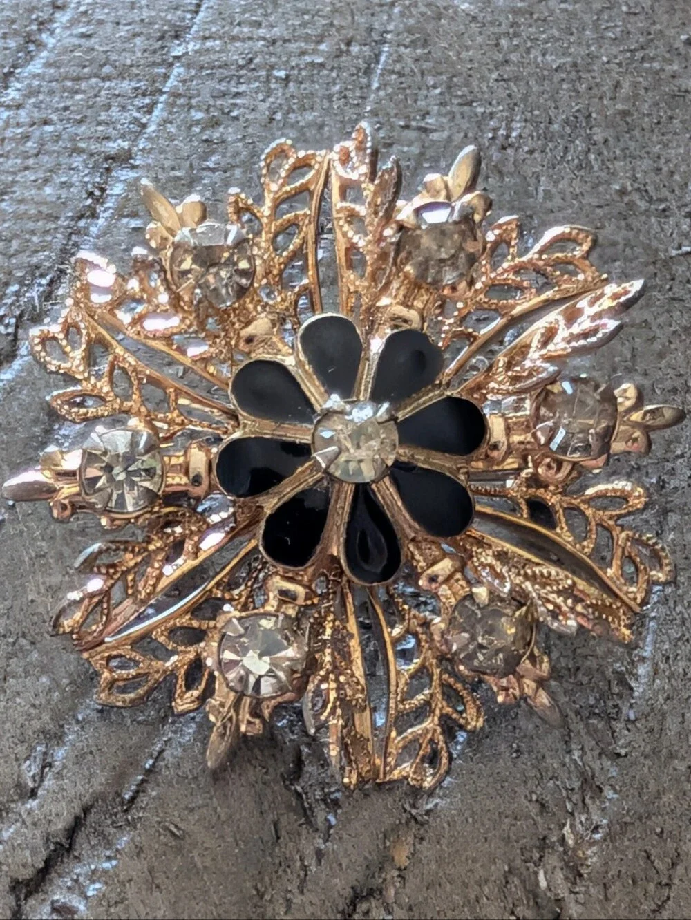 Gold-Tone Filigree Floral Starburst Brooch with Black Enamel and Clear Crystals
